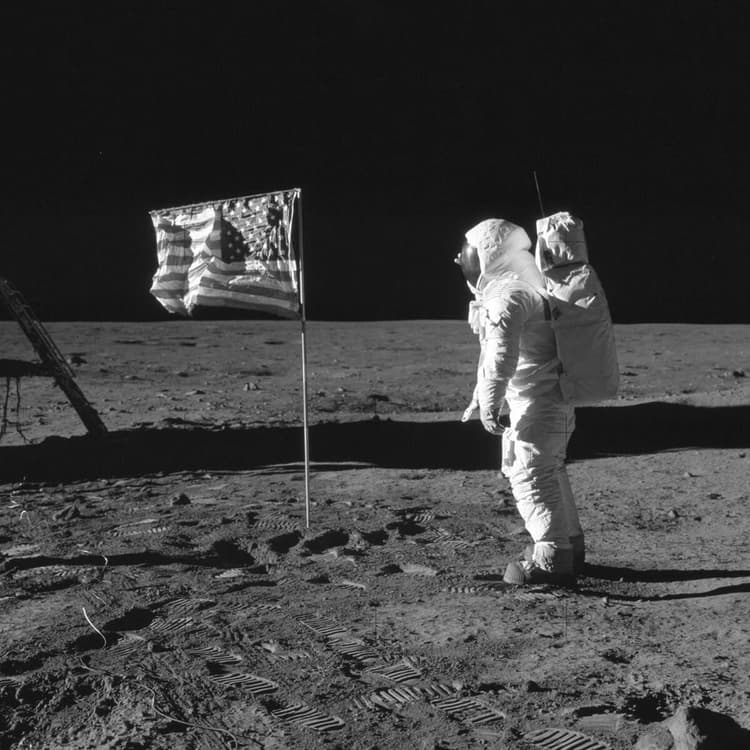 Astronaut on moon with American flag during first moon landing