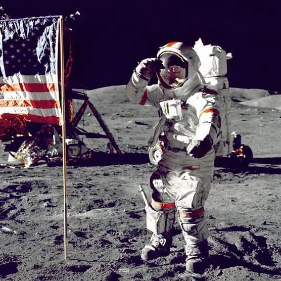 Astronaut on moon with American flag during first moon landing